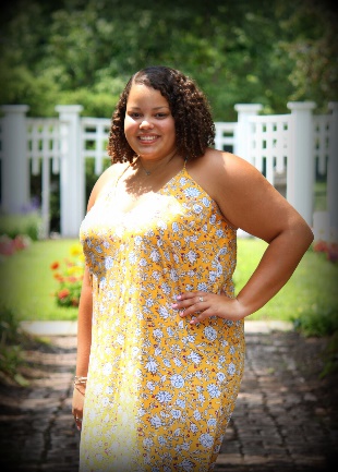 A person in a yellow dress Description automatically generated