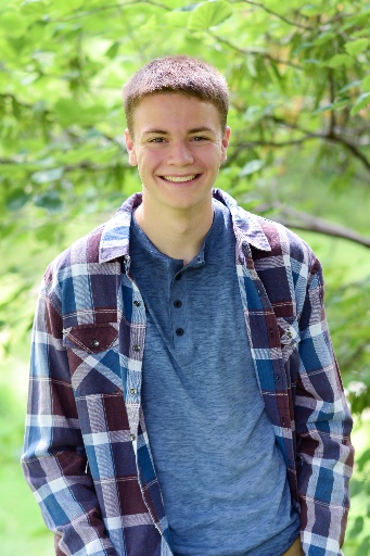 A person smiling for the camera Description automatically generated