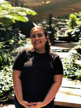 A person standing in front of it Description automatically generated