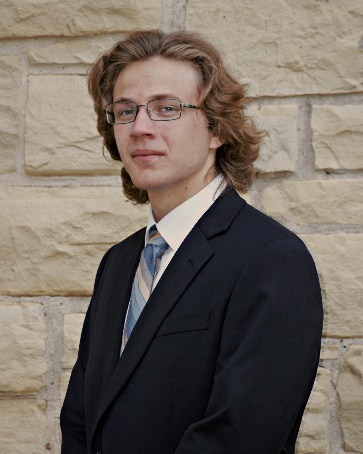 A person wearing a suit and tie Description automatically generated