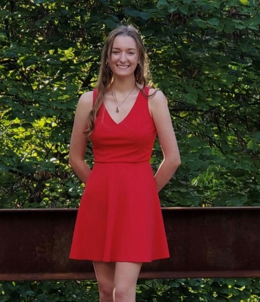 A person in a red dress

Description automatically generated