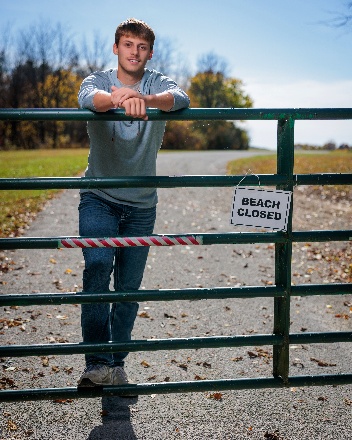 A person leaning on a fence AI-generated content may be incorrect.